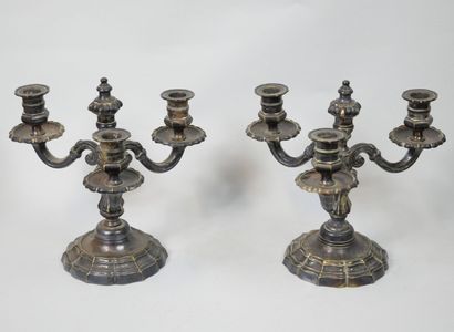 null Pair of candlesticks in silver plated metal, the base with curved edges, the...