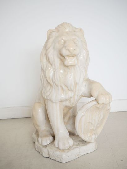 Ceramic sculpture of a lion leaning on a...