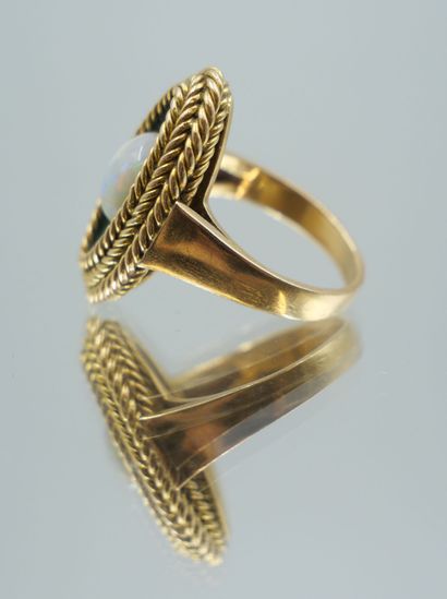 null Oval-shaped ring in 750 thousandths gold with a basketweave design centered...