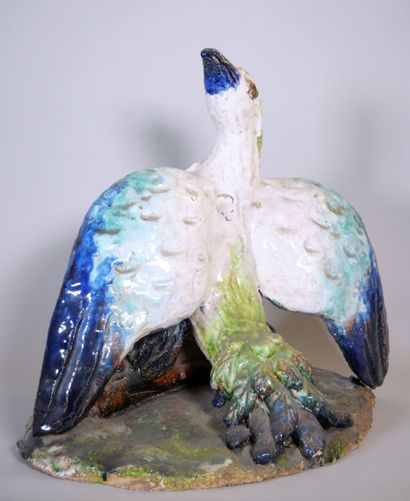 null Polychrome-glazed terra cotta subject depicting a bird with spread wings resting...