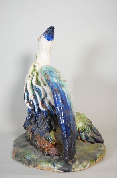 null Polychrome-glazed terra cotta subject depicting a bird with spread wings resting...