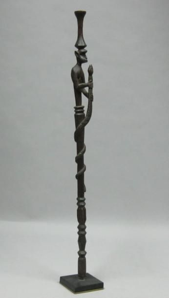 Afrique* Bâton en bois sculpté à décor d'un personnage et d'un serpent. H: 73 cm