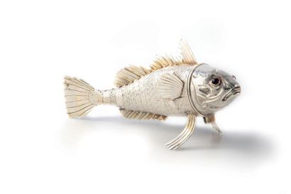 POISSON Articulated silver fish. Bulging eyes are made of a glass or garnet. The...