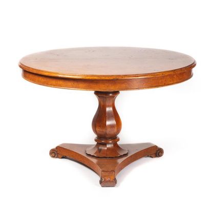 null Beautiful dining room table in light wood veneer. The round or oval-shaped top...