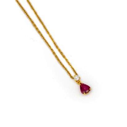 null Yellow gold chain adorned with a pendant in drop of ruby punctuated with a small...