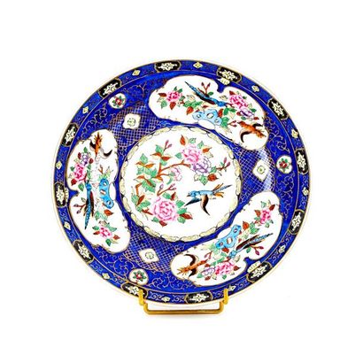 null CHINA
Large round porcelain plate decorated on a blue background of reserves...