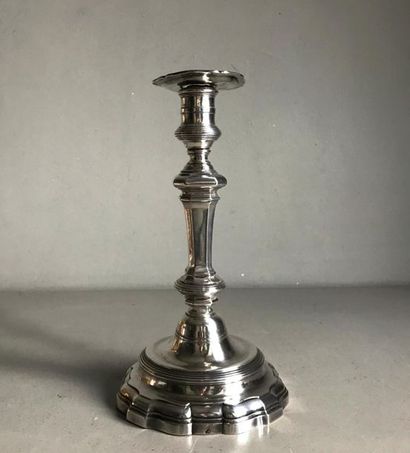 null Candlestick in the shape of a silver baluster. The barrel with cut-off sides...