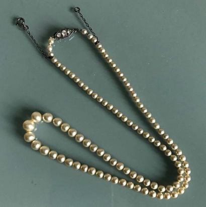 null Falling cultured pearl necklace. Clasp decorated with white stones. Circa 1...