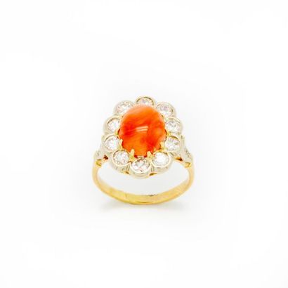 null Yellow gold ring forming a daisy, with an angel skin coral cabochon centre surrounded...