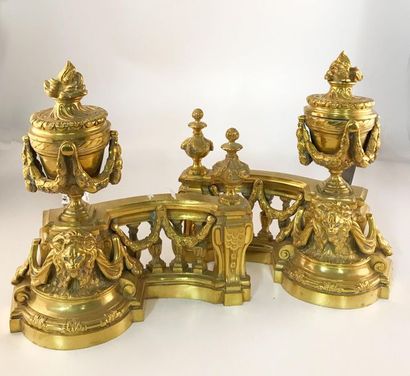 null Pair of bronze and gilded brass andirons. Model with flamed pots, balustrades...