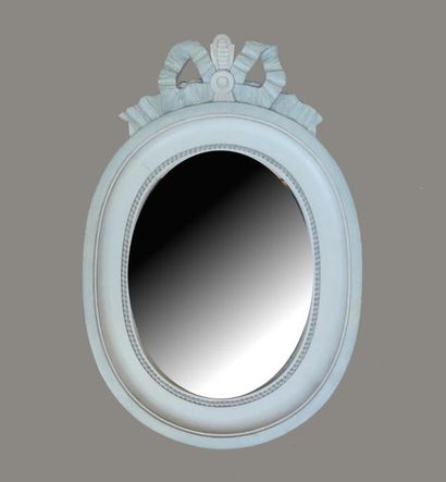 null Oval shaped mirror in white lacquered wood with a chiselled rebate and a frieze...