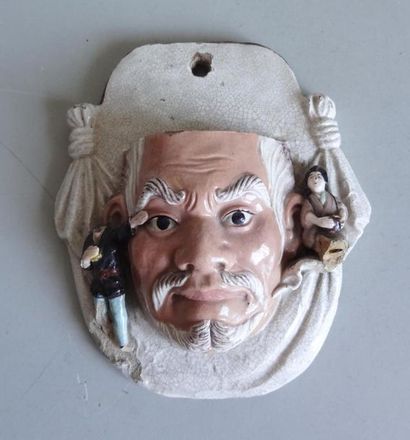 null JAPAN
Polychrome glazed ceramic wall lamp (?) in the shape of a man's face framed...