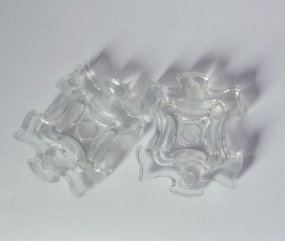 null Two white moulded glass pockets in the shape of a jigsaw puzzle piece that can...