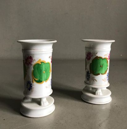 null PARIS
Pair of small tubular porcelain vases with polychrome decoration resting...