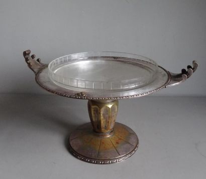 null Large fruit bowl on a pedestal with a silvery metal structure chiselled with...