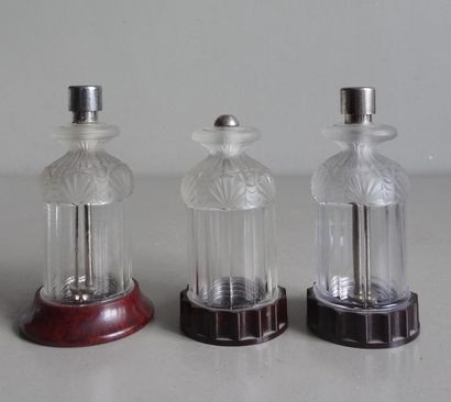 null Maison NOVEX
Three moulded glass flasks with leaf decoration resting on a bakelite...