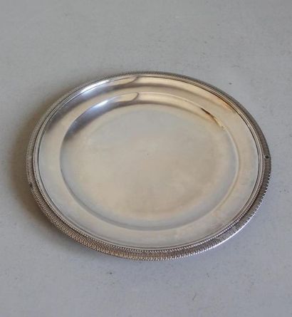null Small round silver platter with a chiselled border of a frieze of water leaves...