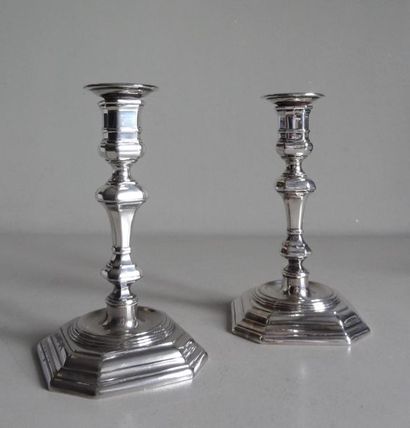 null Pair of small candleholders in silvery metal. Shaft turned into a baluster resting...