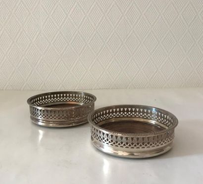 null Pair of coasters with wooden bottom and silver metal openwork border. Probably...