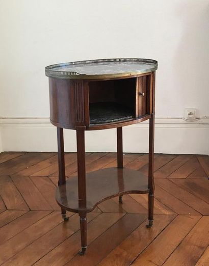null Oval-shaped bedside table in mahogany and mahogany veneer. It opens by a curtain...