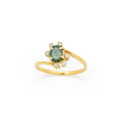 Yellow gold ring set with an emerald and...