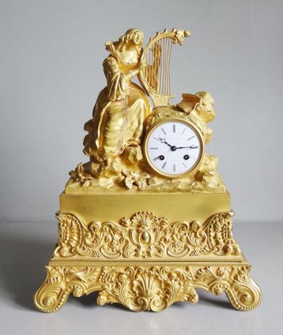 null Gilt bronze clock with a romantic subject representing a young woman playing...