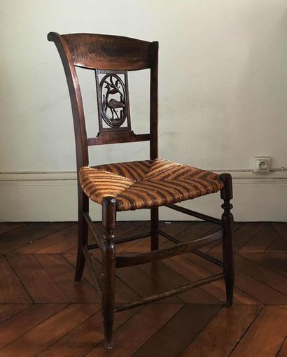 null Natural wood chair with openwork backrest with a carved medallion. Two-tone...