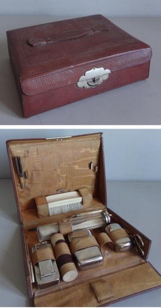 null Leather hairdressing travel kit containing various metal boxes and ivory utensils...