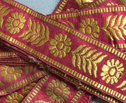 null Set of silk braids with gold decoration on a red background of palmettes and...