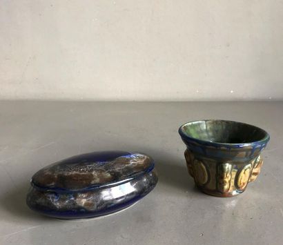 null A covered box and a small flamed ceramic bowl in the style of Pierrefonds.
The...