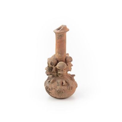 null NIGERIA. 
Terracotta vase with a long neck, the belly is modelled with stylised...