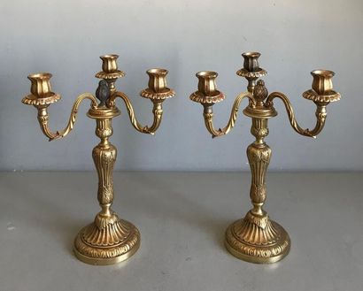 null Pair of gilt bronze torches. The shaft in fluted baluster and chiselled with...