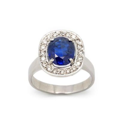 null White gold ring, set with a royal blue sapphire weighing 3.21ct, surrounded...