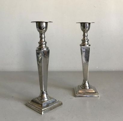 null Pair of metal candleholders with square section shaft on a pagoda base in a...