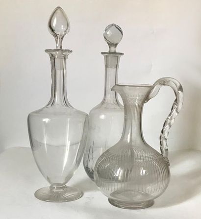 null Two covered flat-bottomed crystal decanters and a glass jug (mismatched) 
H....