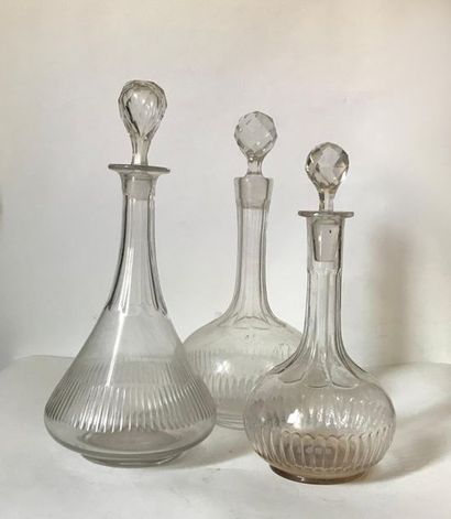 null Three covered flat-bottomed crystal and glass carafes (unpaired) 
H. 32 and...