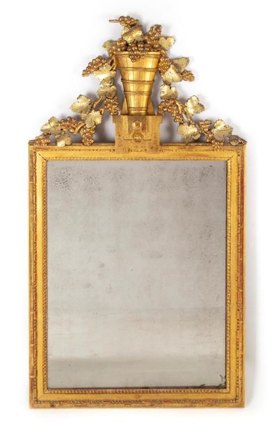 null Rectangular gilded wood mirror with a pediment decorated with vine branches...