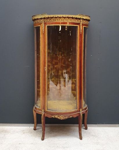 null Curved display case in veneer wood and rich ormolu and gilded brass ornamentation...