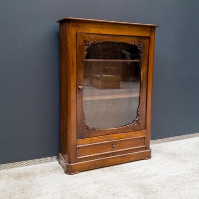 null Small low display case in natural wood opening by a glass door with a cut-out...