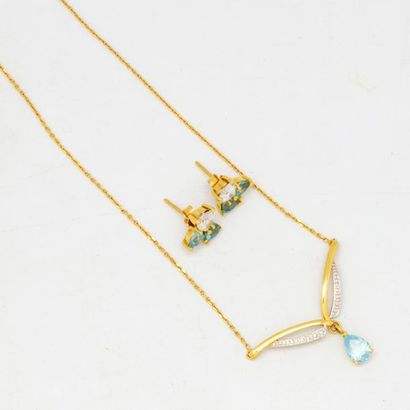 null A yellow gold necklace adorned with a fine chain ending with a pendant set with...