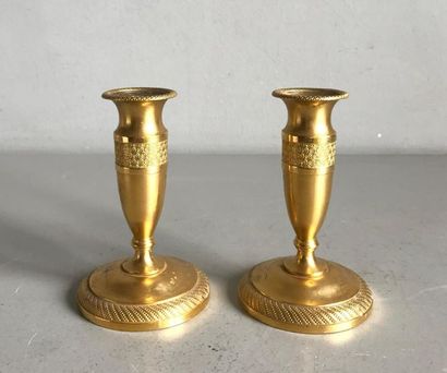 null Pair of small gilt bronze toilet candleholders chiselled with piastres and torsos...