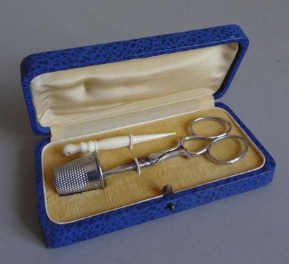 null Sewing kit comprising: scissors - a thimble and an ivory
needle In a case