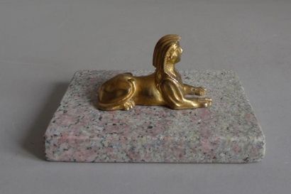 null Paperweight with a rectangular stone base on which rests an Egyptian sphinx...