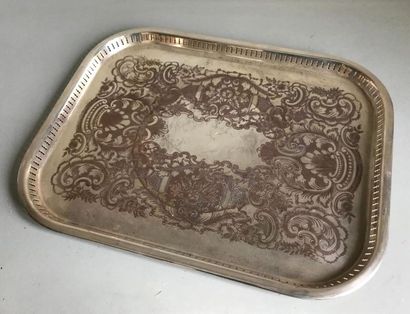 null Large metal serving tray with engraved bottom and openwork edge.
English 
work...