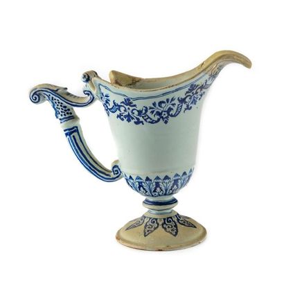 ROUEN ROUEN Earthenware helmet 
ewer with blue-white decoration of mantling and gurilandes...