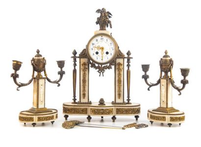 null White marble mantel set with gilded brass ornaments composed of a portico clock...