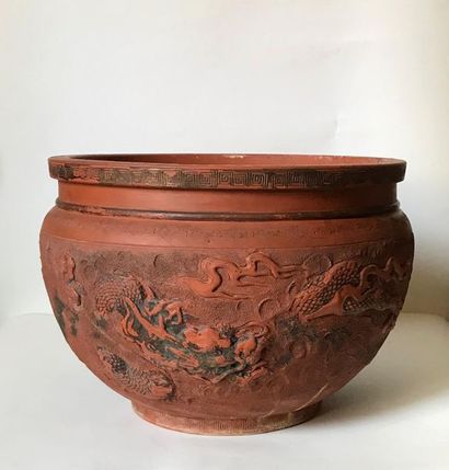 null CHINA
Large terracotta planter with revolving decoration of dragons in relief
H....