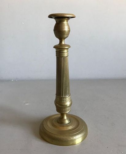 null Gilt bronze candleholder with fluted shaft resting on a circular base chiselled...