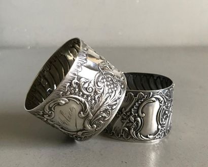 null Two silver napkin rings richly chased with Rocaille motifs around a medallion....
