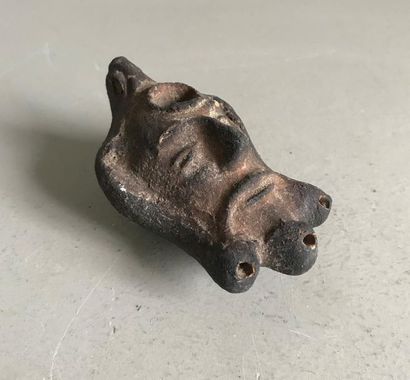null Terracotta oil lamp in the shape of a head of a character in the style of Ancient...